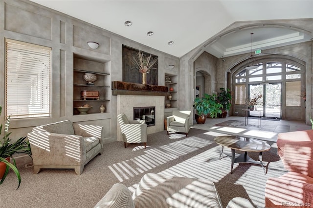 8626 Gold Peak Dr Unit B, Highlands Ranch, CO 80130 - living room featuring built in shelves, a fireplace, carpet floors, and high vaulted ceiling