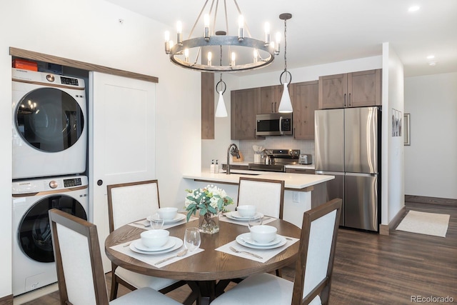 361 Gcr 840 Unit 3, Fraser, CO 80442 - dining area featuring stacked washer / dryer, a chandelier, dark wood-style floors, and recessed lighting