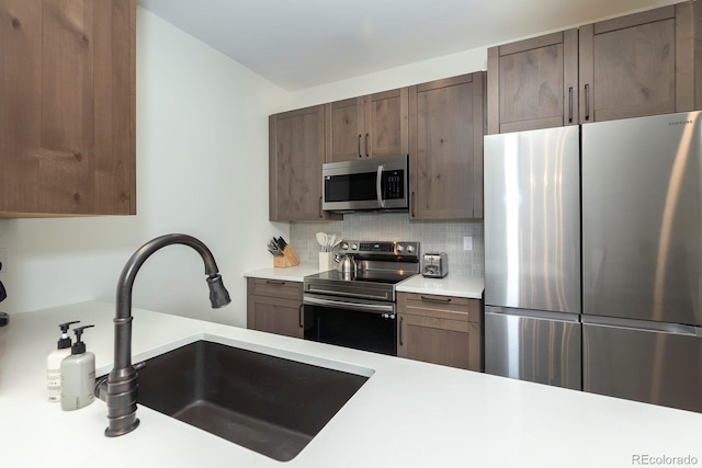 361 Gcr 840 Unit 3, Fraser, CO 80442 - kitchen featuring appliances with stainless steel finishes, light countertops, decorative backsplash, and dark brown cabinets