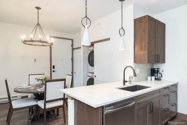 361 Gcr 840 Unit 3, Fraser, CO 80442 - kitchen with estacked washer and dryer, dishwasher, dark wood-style flooring, and a chandelier