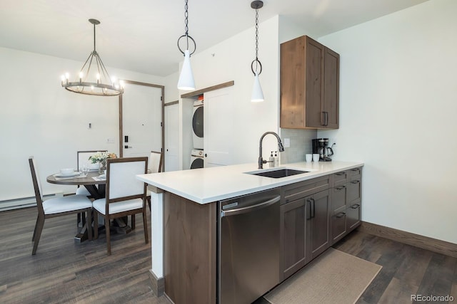 361 Gcr 840 Unit 3, Fraser, CO 80442 - kitchen featuring dishwasher, stacked washing machine and dryer, dark wood finished floors, a chandelier, and tasteful backsplash