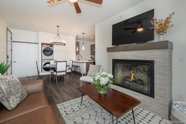361 Gcr 840 Unit 3, Fraser, CO 80442 - living area featuring stacked washer and clothes dryer, a ceiling fan, wood finished floors, and a fireplace