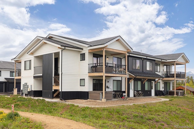 361 Gcr 840 Unit 3, Fraser, CO 80442 - rear view of house featuring a hot tub, a balcony, and roof with shingles