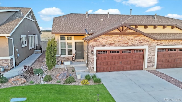 11307 Rill Pt, Colorado Springs, CO 80921 - view of front of property featuring stone siding, concrete driveway, a shingled roof, and stucco siding