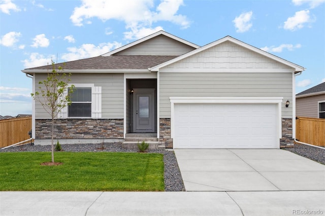 view of front of house with a garage and a front lawn