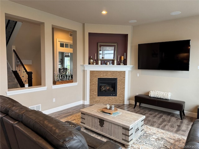 7692 Weaver Cir, Castle Rock, CO 80104 - living area featuring stairs, wood finished floors, recessed lighting, and a tiled fireplace