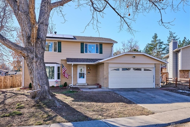 view of front property featuring solar panels and a garage