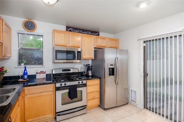 9675 E Kansas Cir Unit 48, Denver, CO 80247 - kitchen featuring appliances with stainless steel finishes, light brown cabinets, and light tile patterned flooring