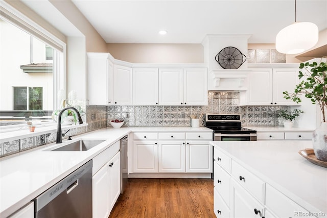 7038 Russell Ct, Arvada, CO 80007 - kitchen with stainless steel appliances, a sink, backsplash, healthy amount of natural light, and recessed lighting