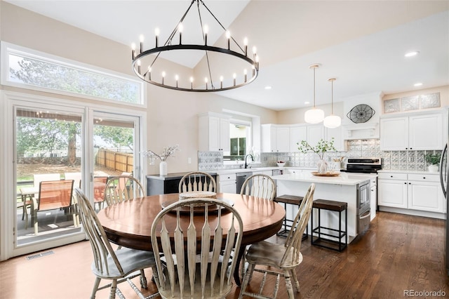 7038 Russell Ct, Arvada, CO 80007 - dining area featuring dark wood-style floors, a chandelier, and recessed lighting