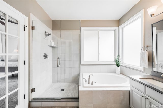 7038 Russell Ct, Arvada, CO 80007 - bathroom with a bath, vanity, and a stall shower