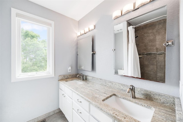 7038 Russell Ct, Arvada, CO 80007 - full bathroom with double vanity and tiled shower