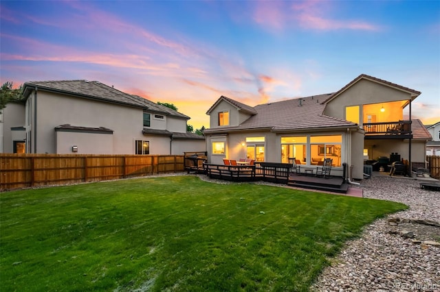 7038 Russell Ct, Arvada, CO 80007 - back of property at dusk with an outdoor hangout area, stucco siding, a tile roof, and a patio