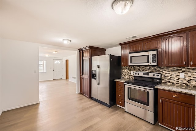 4730 S Huron St, Englewood, CO 80110 - kitchen featuring stainless steel appliances, light wood finished floors, backsplash, and dark brown cabinets