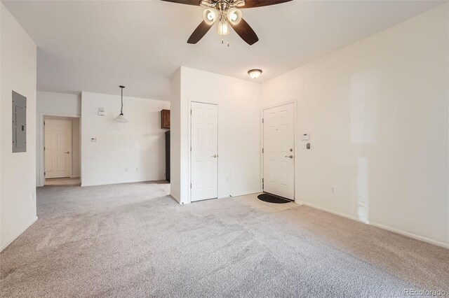 carpeted spare room with electric panel and ceiling fan