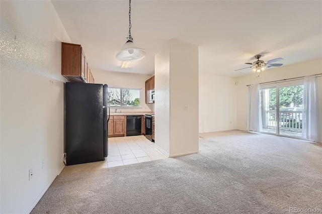 unfurnished living room featuring light colored carpet and a wealth of natural light