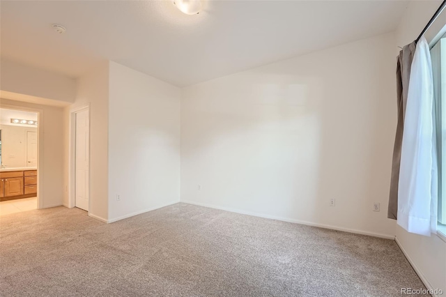 empty room featuring light colored carpet