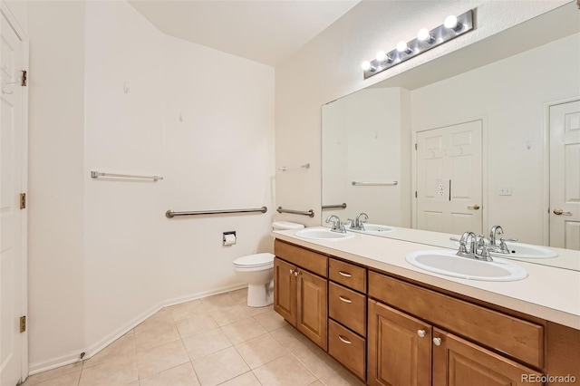 bathroom featuring vanity, tile patterned flooring, and toilet