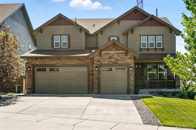 7949 S Elk Way, Aurora, CO 80016 - craftsman-style home featuring stone siding, driveway, an attached garage, covered porch, and a front lawn
