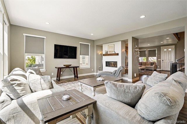 7949 S Elk Way, Aurora, CO 80016 - living area featuring wood finished floors, recessed lighting, and a glass covered fireplace
