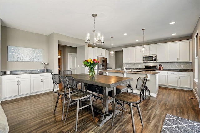 7949 S Elk Way, Aurora, CO 80016 - dining room featuring dark wood finished floors, a chandelier, and recessed lighting