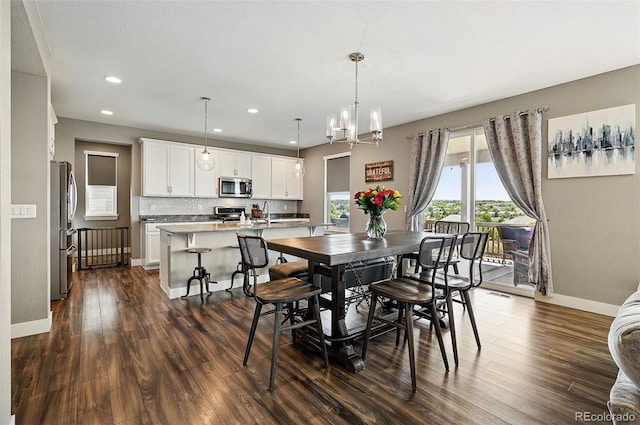 7949 S Elk Way, Aurora, CO 80016 - dining space featuring dark wood-style flooring, recessed lighting, and a chandelier
