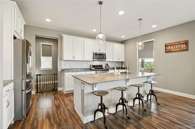 7949 S Elk Way, Aurora, CO 80016 - kitchen featuring appliances with stainless steel finishes, dark wood-style flooring, backsplash, recessed lighting, and white cabinets