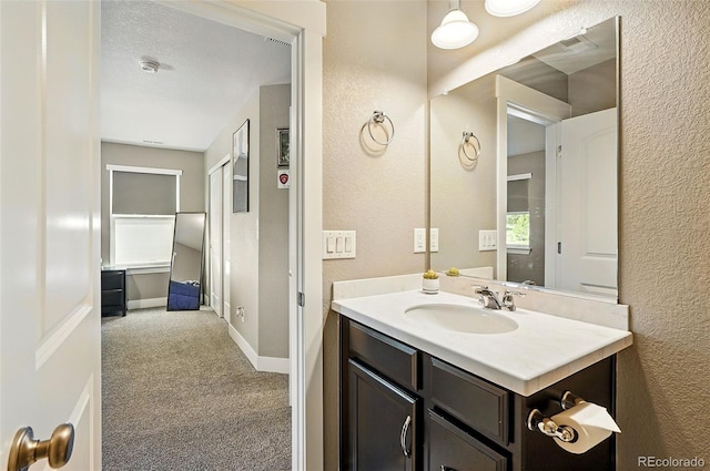 7949 S Elk Way, Aurora, CO 80016 - bathroom featuring a textured wall and vanity
