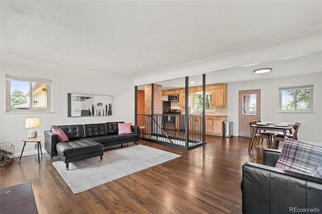 living area featuring dark wood finished floors and baseboards