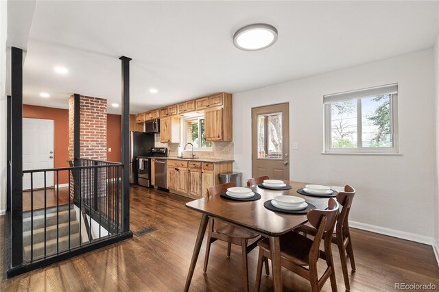 dining room featuring baseboards, dark wood-type flooring, and recessed lighting