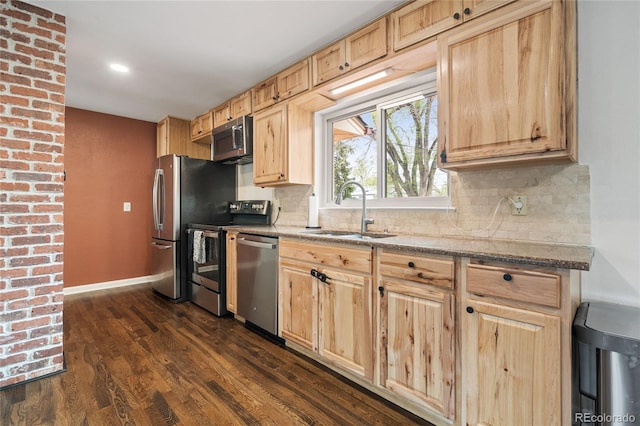 kitchen featuring light brown cabinets, a sink, backsplash, appliances with stainless steel finishes, and dark wood-type flooring