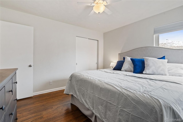 bedroom featuring a ceiling fan, baseboards, and dark wood finished floors