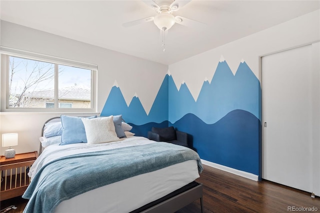 bedroom with baseboards, wood finished floors, and ceiling fan