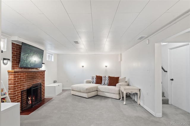 carpeted living area with a brick fireplace, stairway, visible vents, and baseboards