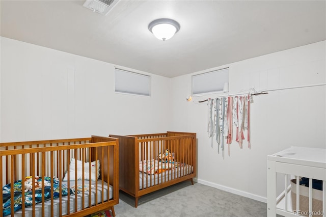 carpeted bedroom featuring baseboards and visible vents