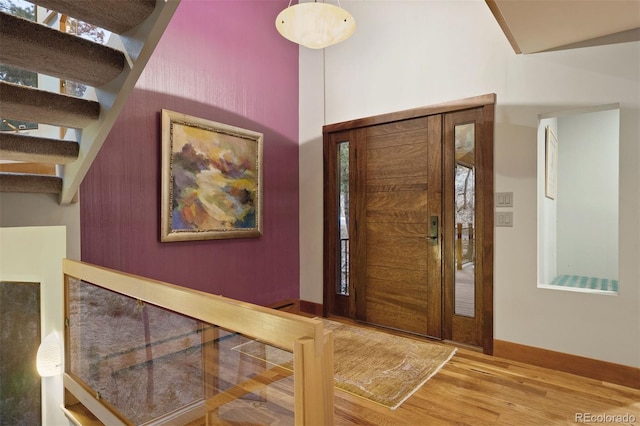 entryway featuring wood finished floors and baseboards