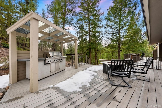 wooden terrace with grilling area and an outdoor kitchen