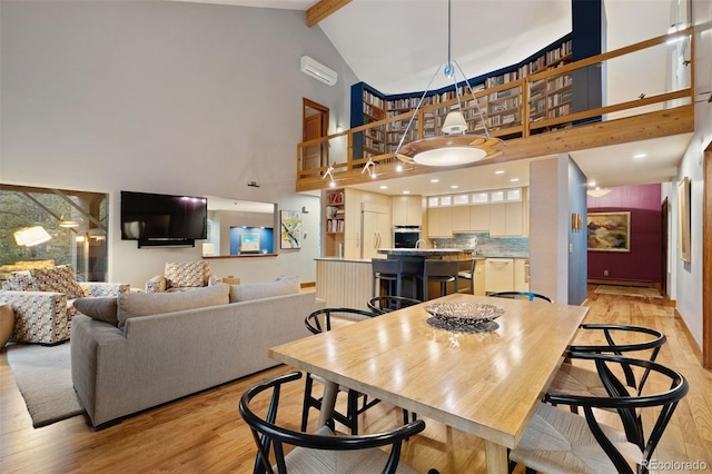 dining area featuring light wood finished floors, baseboards, a baseboard radiator, high vaulted ceiling, and beam ceiling