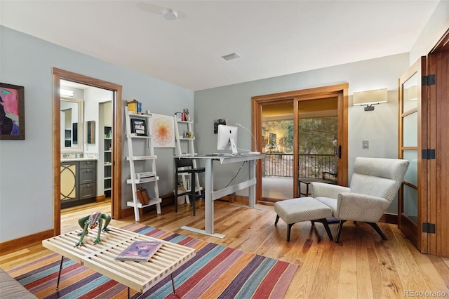 sitting room with light wood-style flooring and baseboards