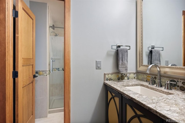 full bath featuring a shower stall and vanity