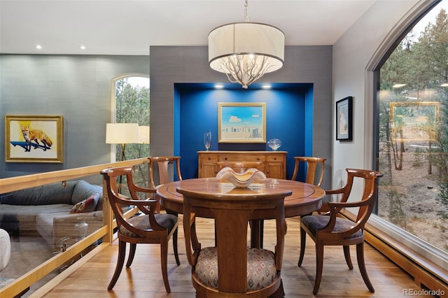 dining space featuring a notable chandelier, wood finished floors, and recessed lighting