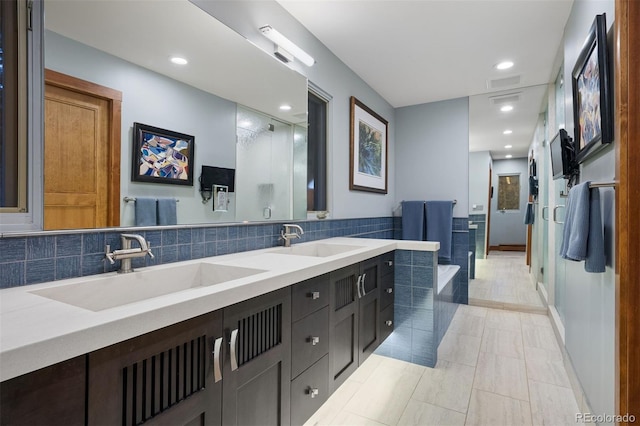 bathroom with double vanity, a stall shower, a sink, and a bath