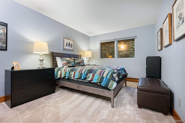 bedroom featuring light carpet and baseboard heating