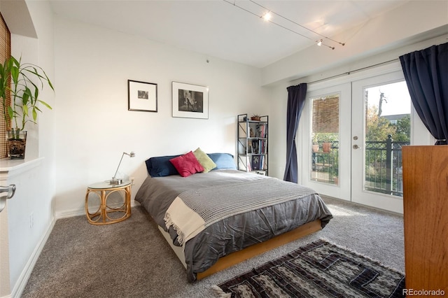 carpeted bedroom with access to exterior, french doors, and track lighting