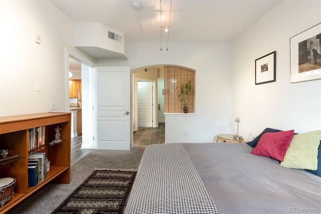 bedroom featuring dark colored carpet