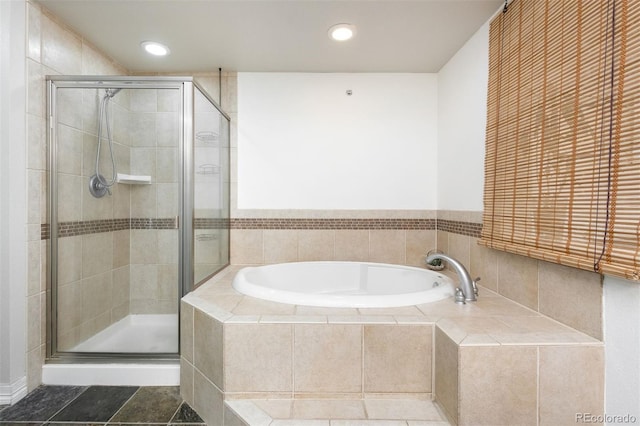 bathroom featuring separate shower and tub