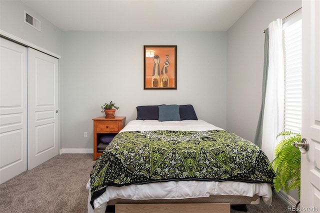 carpeted bedroom with multiple windows and a closet