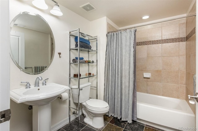 bathroom with toilet and shower / tub combo with curtain