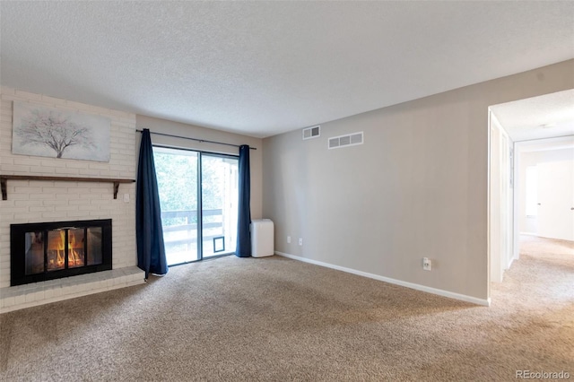 unfurnished living room with a textured ceiling, carpet flooring, and a brick fireplace