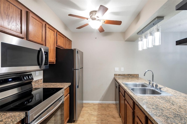 kitchen featuring hanging light fixtures, sink, ceiling fan, and stainless steel appliances